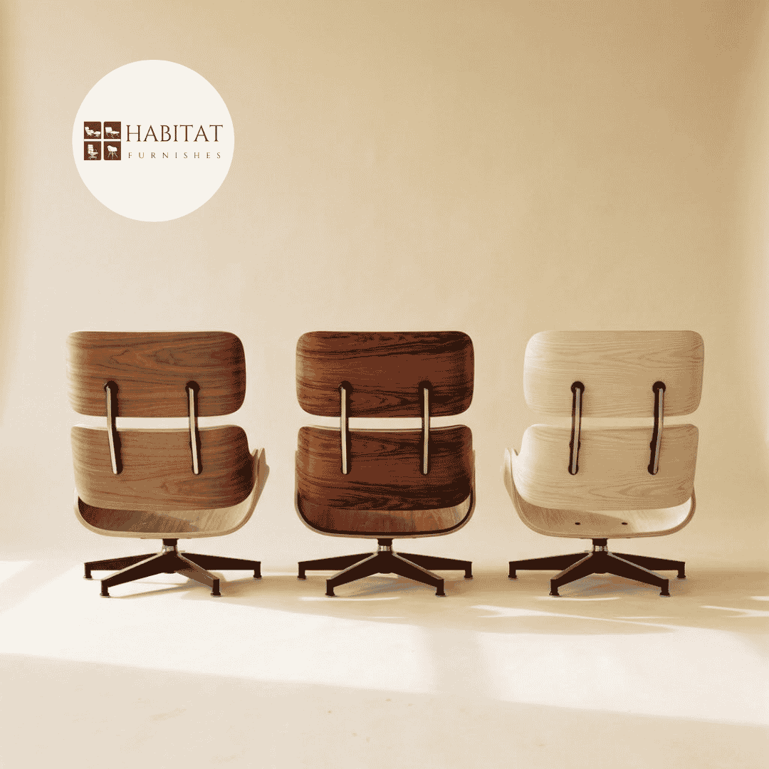 Three Eames style lounge chair shells in walnut, rosewood and ashwood standing side by side in soft north daylight